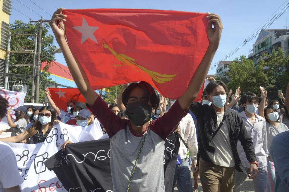 Anti-coup protesters display a party flag of the National League for Democracy (NLD) during a demonstration in Yangon, Myanmar, Friday, May 14, 2021. (AP Photo)