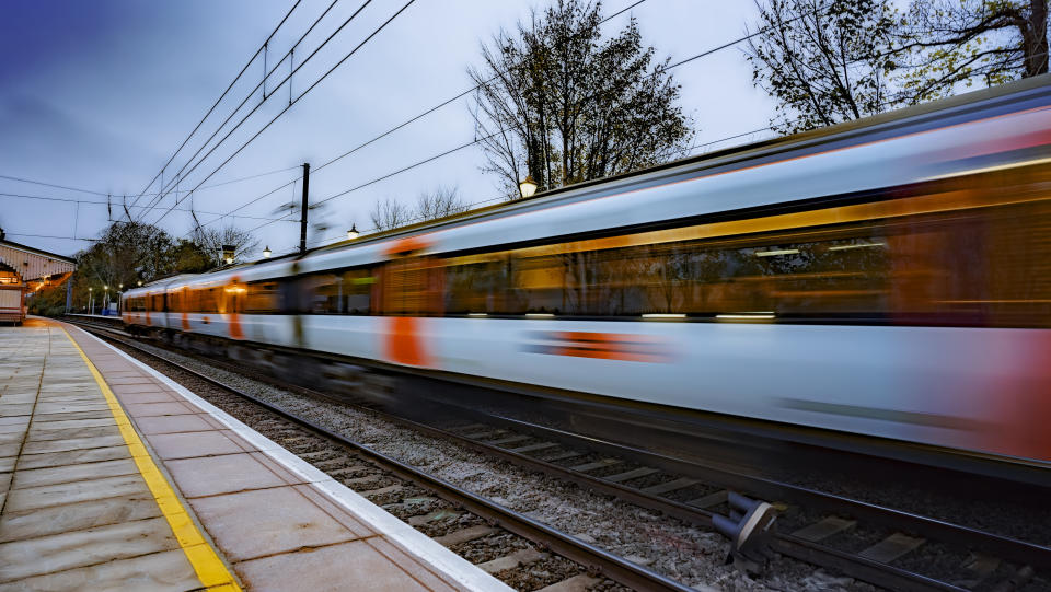 Commuter train departing a station and gathering speed