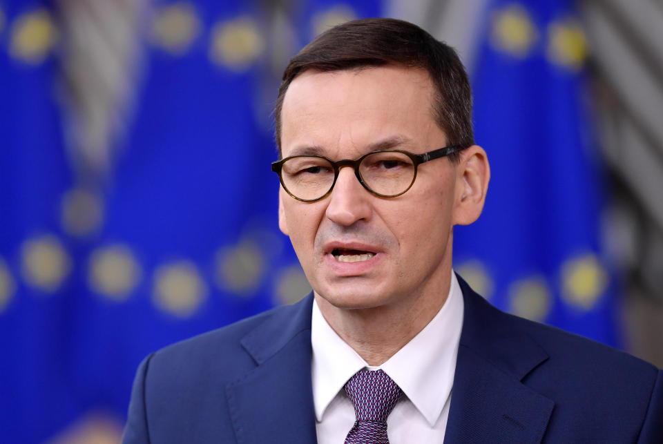 Poland's Prime Minister Mateusz Morawieckij speaks with the media as he arrives for an EU summit at the European Council building in Brussels, Thursday, Dec. 10, 2020. European Union leaders meet for a year-end summit that will address anything from climate, sanctions against Turkey to budget and virus recovery plans. Brexit will be discussed on the sidelines. (John Thys, Pool via AP)