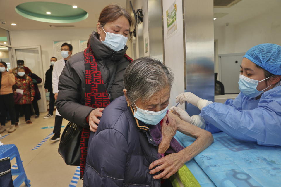 A nurse gives a shot of COVID vaccine to an old woman at a community health center in Nantong in eastern China's Jiangsu province Friday, Dec. 09, 2022. Nearly three years after it was first identified in China, the coronavirus is now spreading through the vast country. Experts predict difficult months ahead for its 1.4 billion people. (Chinatopix Via AP)