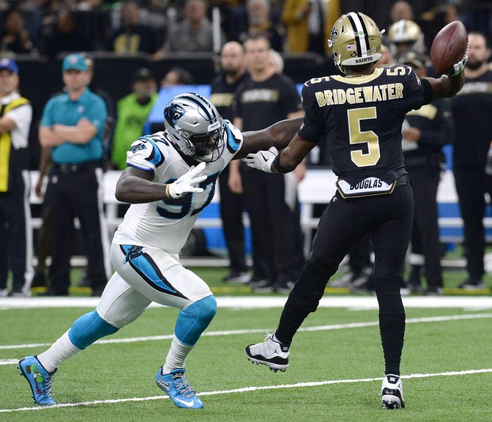 Carolina Panthers defensive end Mario Addison, left, pressures New Orleans Saints quarterback Teddy Bridgewater, right, during first quarter action at the Mercedes-Benz Superdome in New Orleans, LA. on Sunday, December 30, 2018.