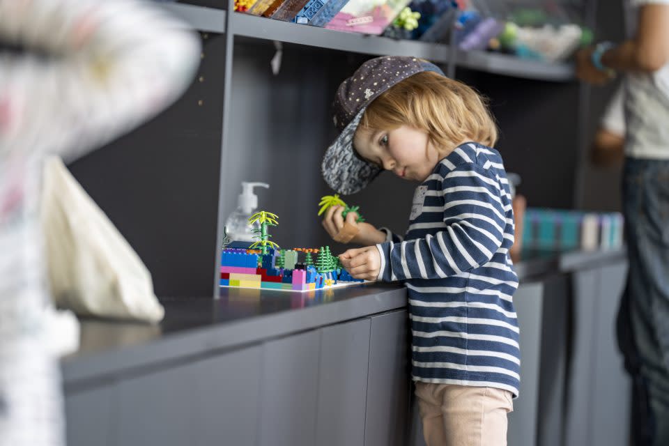 kid playing with lego