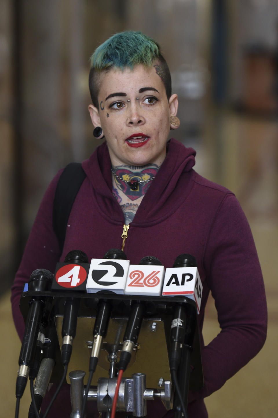 Danielle Silva, of Oakland, Calif., who identified herself as a Max Harris supporter, speaks to the media at the Alameda County Courthouse in Oakland, Calif., Tuesday April, 30, 2019. Two defendants, Derick Almena and Max Harris are standing trial on charges of involuntary manslaughter after a 2016 fire killed 36 people at a warehouse party they hosted in Oakland. (AP Photo/Cody Glenn)