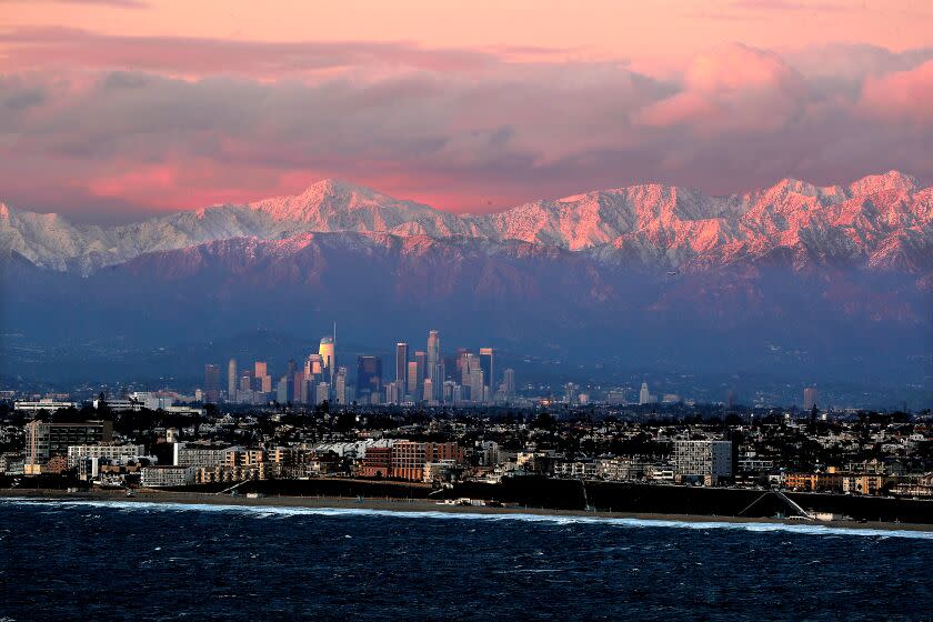 LOS ANGELES, CALIF. - MAR.1, 2023. Snow-covered mountains provide a backdrop for the Los Angeles Basin, from the mountains to downtown to the sea on Wednesday, Mar. 1, 2023. (Luis Sinco / Los Angeles Times)
