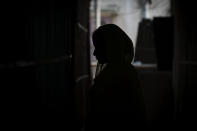 Sonali Begum, 17, stands inside her home as she cries explaining how her husband Siddique Ali, 23, was picked up by the police, at her rented house in Guwahati, India, Saturday, Feb. 4, 2023. Indian police have arrested more than 2,000 men in a crackdown on illegal child marriages in involving girls under the age of 18 a northeastern state. Begum is seven months pregnant. (AP Photo/Anupam Nath)