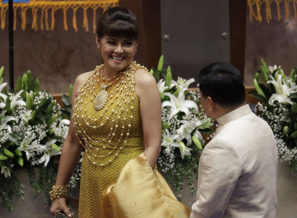 Senator Imee Marcos, daughter of the late strongman Ferdinand, talks to a representative as she attends Philippine President Rodrigo Duterte's 4th State of the Nation Address at the House of Representatives in Quezon city, metropolitan Manila, Philippines Monday July 22, 2019. (AP Photo/Aaron Favila)