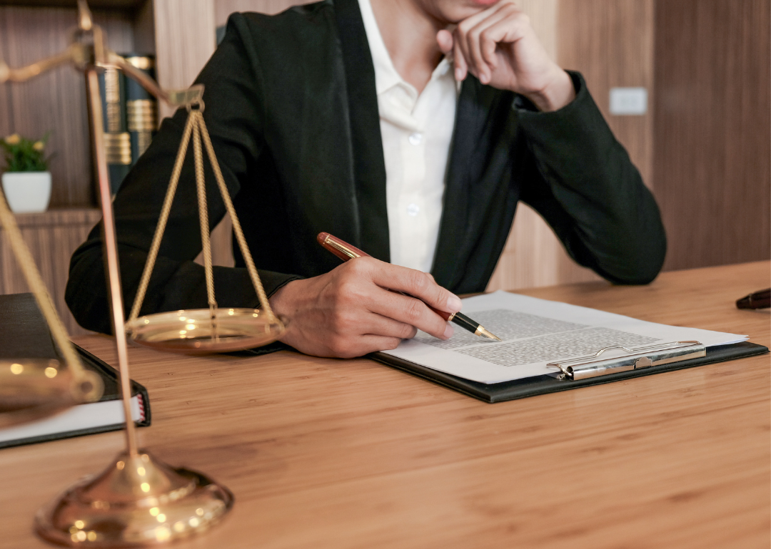 Legal counsel sitting with a contract.