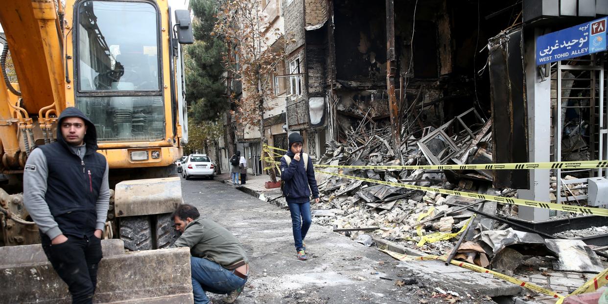 FILE PHOTO: People walk near a burnt bank, after protests against increased fuel prices, in Tehran, Iran November 20, 2019. Picture taken November 20, 2019. Nazanin Tabatabaee/WANA (West Asia News Agency) via REUTERS/File Photo