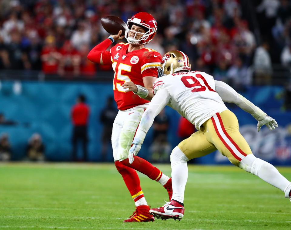 Feb 2, 2020; Miami Gardens, Florida, USA; Kansas City Chiefs quarterback Patrick Mahomes (15) scrambles out of the pocket under pressure from San Francisco 49ers defensive tackle Arik Armstead (91) in Super Bowl LIV at Hard Rock Stadium. Mandatory Credit: Matthew Emmons-USA TODAY Sports