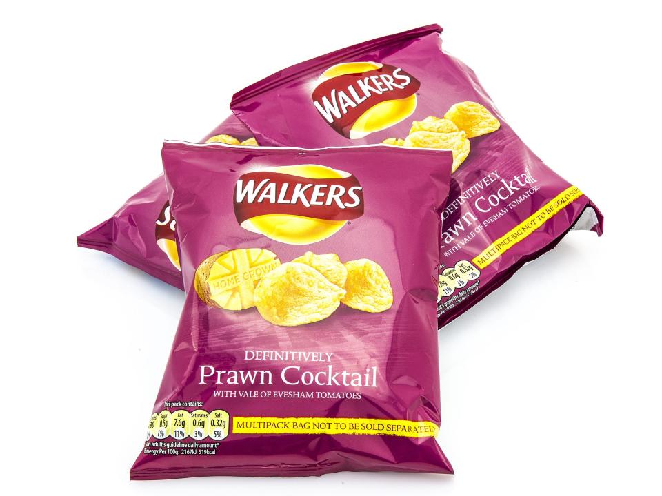 Walkers prawn cocktail crisps pink bags on white background