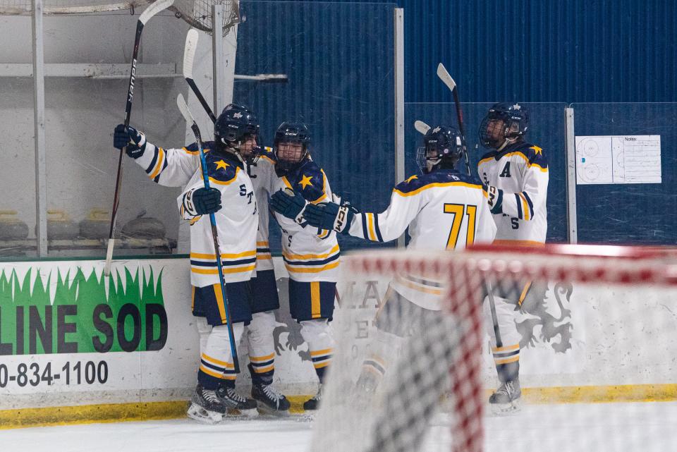 Poudre School District ice hockey players celebrate after scoring a goal during a game against Cherry Creek on Friday, January 26, 2024, at NoCo Ice Center in Windsor, Colo.