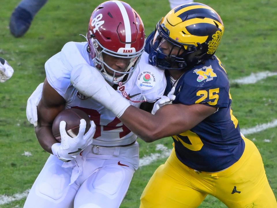 Michigan Wolverines linebacker Junior Colson (25) tackles Alabama Crimson Tide tight end Amari Niblack (84) during the 2nd quarter of the 2024 Rose Bowl college football playoff semifinal game at Rose Bowl.