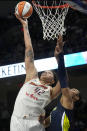 Phoenix Mercury center Brittney Griner (42) shoots as Dallas Wings forward Satou Sabally defends during the second half of a WNBA basketball game Wednesday, June 7, 2023, in Arlington, Texas. (AP Photo/Tony Gutierrez)