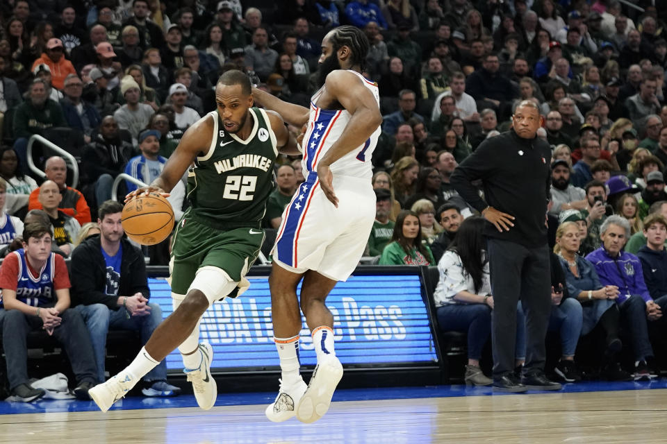 Milwaukee Bucks' Khris Middleton (22) drives to the basket against Philadelphia 76ers' James Harden during the second half of an NBA basketball game Saturday, March 4, 2023, in Milwaukee. (AP Photo/Aaron Gash)