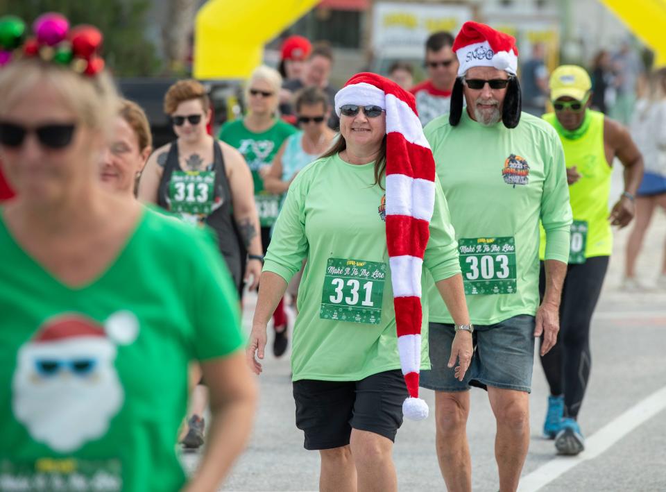 Walkers break from the starting line during a past Make it to the Line run at the Flora-Bama Lounge.