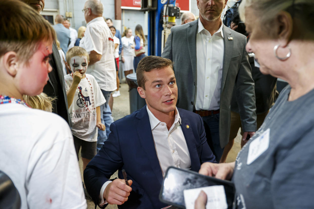 U.S. Rep. Madison Cawthorn, R-N.C., talks to supporters at his primary election night watch party in Hendersonville, N.C., Tuesday, May 17, 2022. (AP Photo/Nell Redmond)