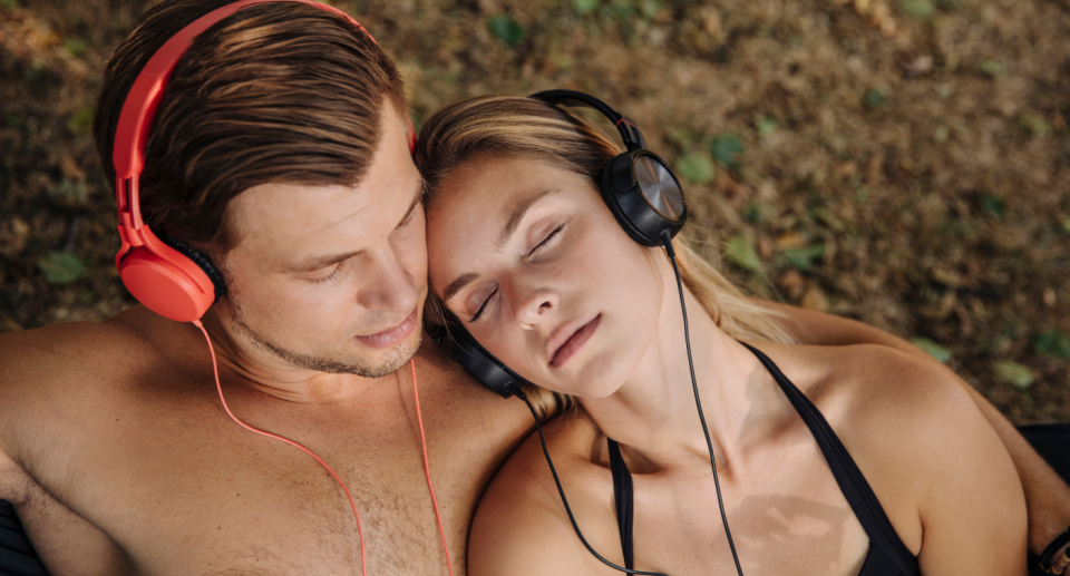 A couple with headphones on. 