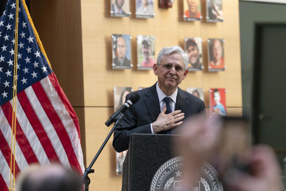 Attorney General Merrick Garland speaks next to a wall with photographs of victims of gun violence during the Inaugural Gun Violence Survivors' Summit at ATF Headquarters in Washington, Tuesday, April 23, 2024. (AP Photo/Jose Luis Magana)