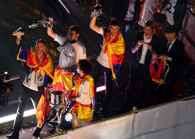 (FromL) Real Madrid's Sergio Ramos, Iker Casillas, Pepe, Nacho, Fabio Coentrao and Cristiano Ronaldo pose with the Copa del Rey trophy at Plaza Cibeles in Madrid on April 17, 2014