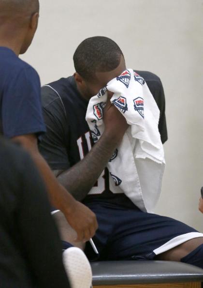 DeMarcus Cousins wipes his face after injuring his right knee. (AP)