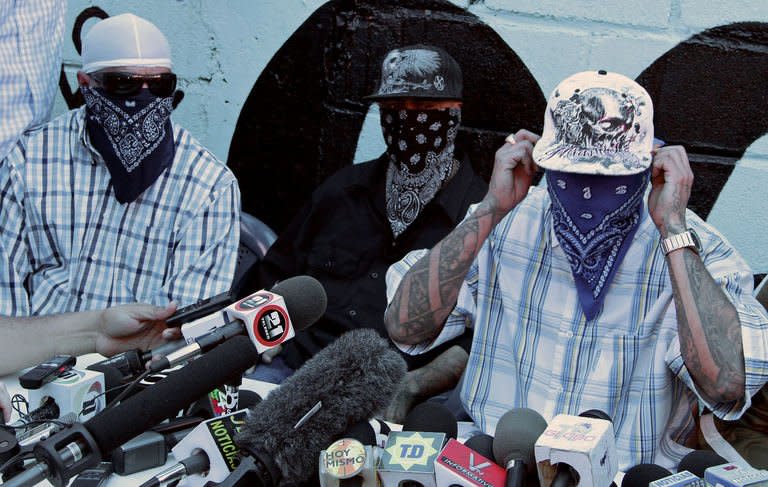 Members of the Mara Salvatrucha (MS-13) gang give a press conference at a prison in San Pedro Sula, 240 km north of Tegucigalpa, on May 28, 2013. MS-13 and another ultra-violent Honduran gang apologized Tuesday for their crimes and declared they were willing to discuss a truce to cut violence in the nation with the world's highest murder rate