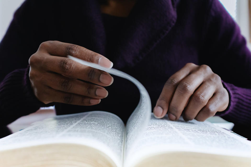 hands turning pages in a book