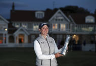 South Africa's Ashleigh Buhai poses for the media holding the trophy after winning the Women's British Open golf championship, during the presentation ceremony in Muirfield, Scotland, Sunday, Aug. 7, 2022. (AP Photo/Scott Heppell)