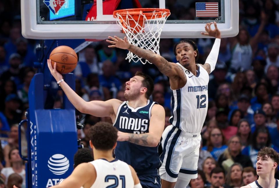 Luka Doncic tries to score against Ja Morant