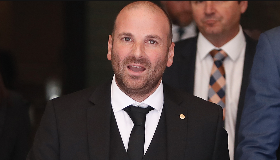 George Calombaris in a black suit 