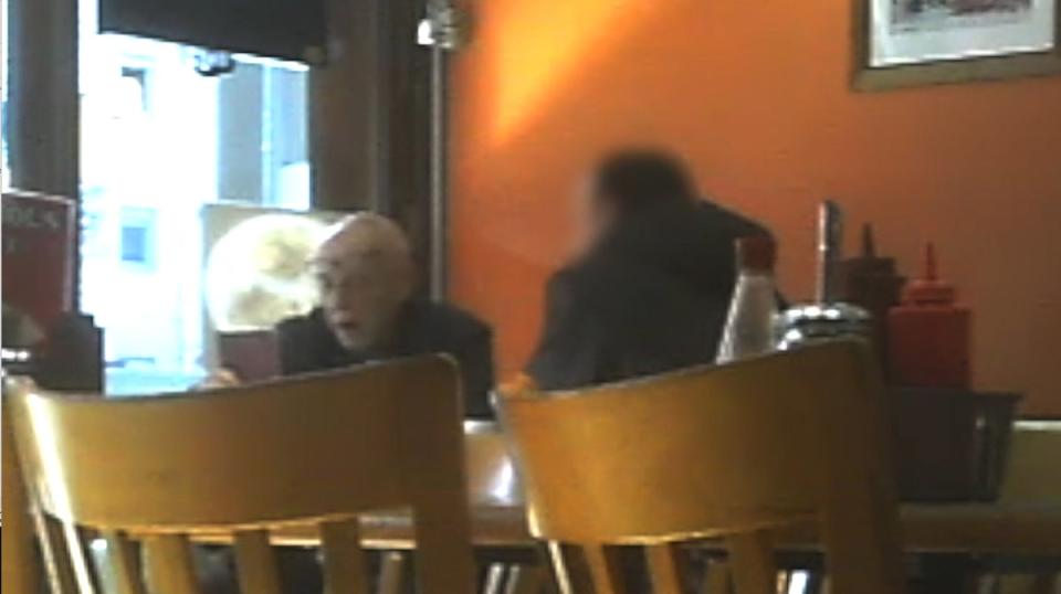 Anthony Beard, inspecting a passport at a cafe in New Cross (National Crime Agency/PA Wire)