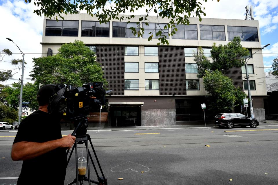 A television cameraman films a hotel, where Serbia's Novak Djokovic is believed to be in, in Melbourne, Australia, Thursday, Jan. 6, 2022. Djokovic's chance to play for a 10th Australian Open title has been thrown into limbo. The country denied him entry and canceled his visa because he failed to meet the requirements for an exemption to COVID-19 vaccination rules. (Joel Carrett/AAP Image via AP)