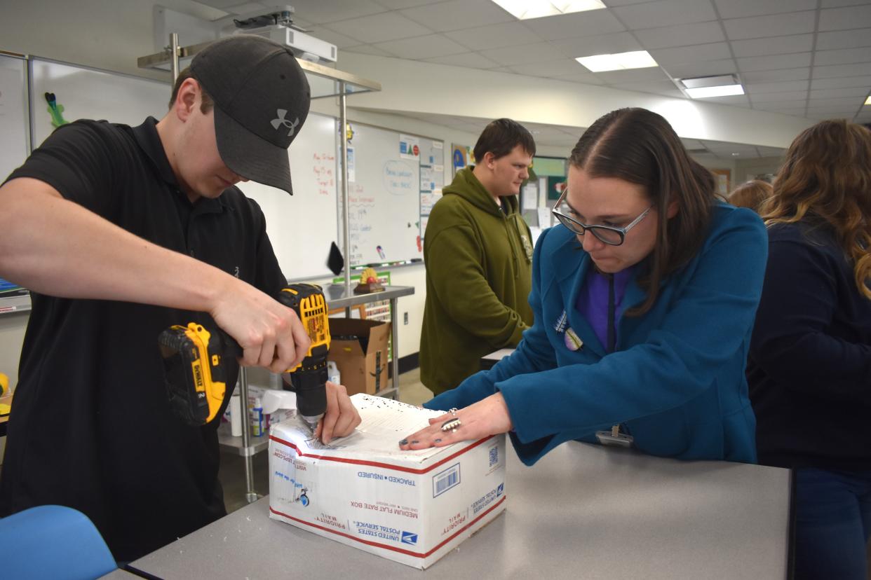 Owen Williams, left, a senior at Tecumseh High School and a student in the Natural Resources program at the Lenawee Intermediate School District (LISD) Tech Center works on drilling holes into a tube so that stainless steel wires can be placed into the holes as part of a water pasteurization project that was conducted last week between the Tech Center FFA students and the Rotary Club of Tecumseh. Assisting Williams with the drilling process was Carley Kratz, Natural Resources instructor for the LISD.