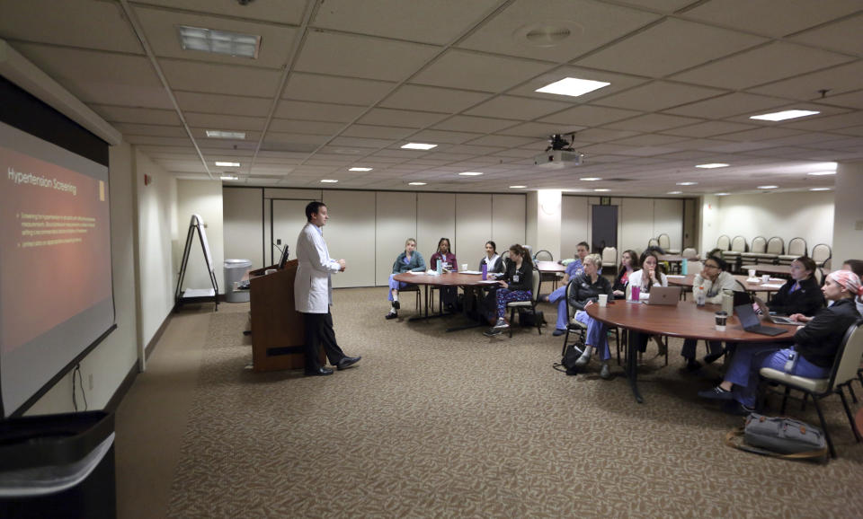 Dr. Keith Reisinger-Kindle, associate director of the OB-GYN residency program at Wright State University's medical school in Dayton, Ohio, leads a lecture of OB-GYN residents in the Wright State program Wednesday, April 13, 2022. (AP Photo/Paul Vernon)