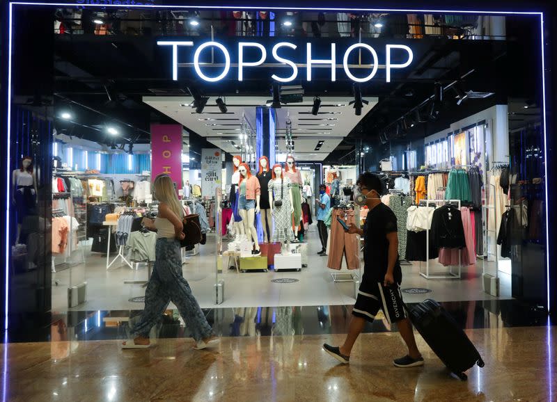 People wearing protective face masks walk at Mall of the Emirates during the reopening of malls, following the outbreak of the coronavirus disease (COVID-19), in Dubai