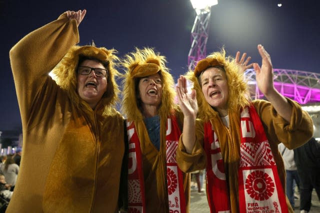 Three England fans dressed as lions at the World Cup final