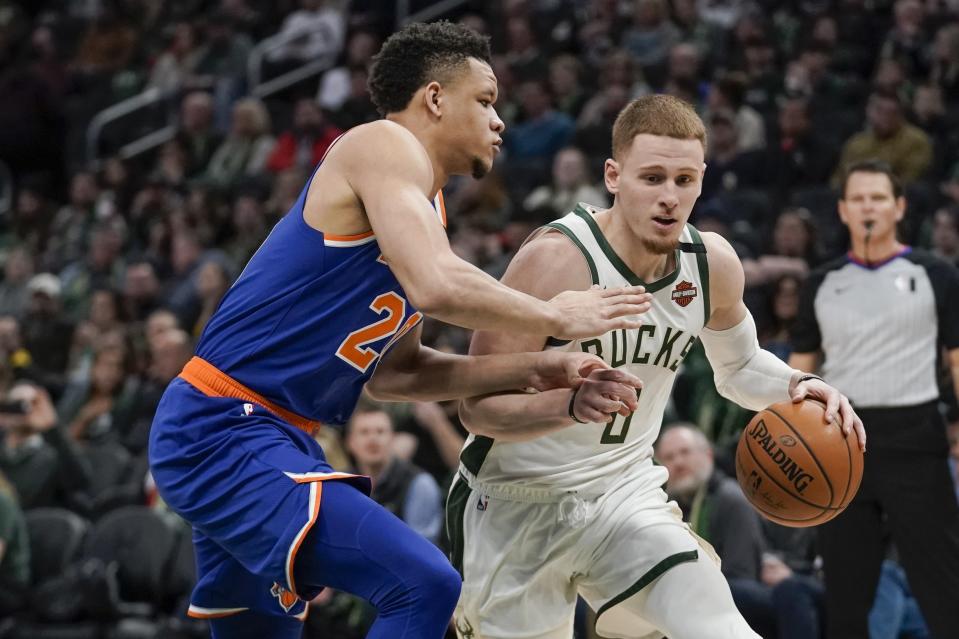 Milwaukee Bucks' Donte DiVincenzo drives past New York Knicks' Kevin Knox II during the second half of an NBA basketball game Tuesday, Jan. 14, 2020, in Milwaukee. (AP Photo/Morry Gash)