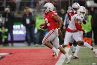 Ohio State running back J.K. Dobbins, left, scores a touchdown against Wisconsin during the second half of an NCAA college football game Saturday, Oct. 26, 2019, in Columbus, Ohio. Ohio State beat Wisconsin 38-7. (AP Photo/Jay LaPrete)
