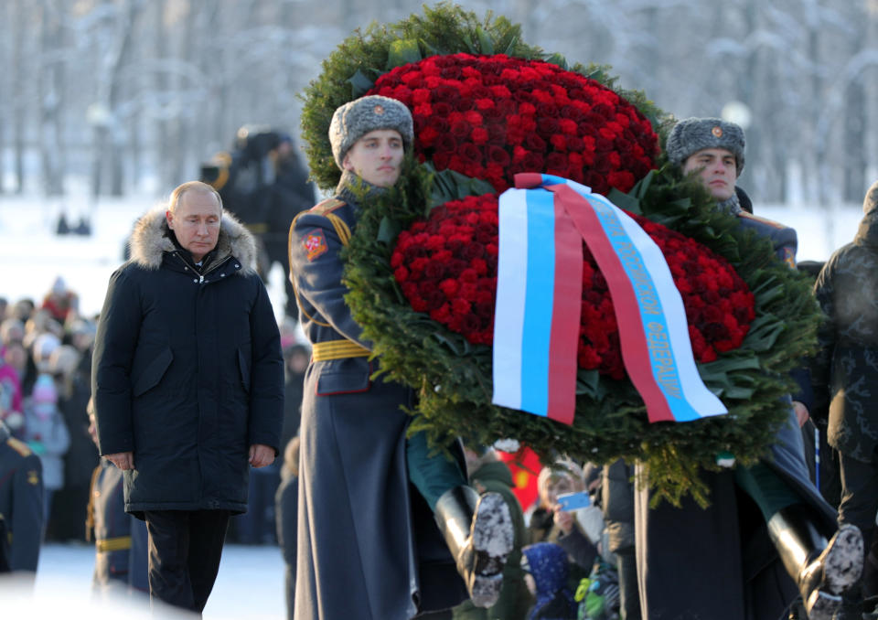 Russian President Vladimir Putin, left, takes part at a wreath laying ceremony at the Piskaryovskoye Cemetery, in St. Petersburg, Russia, Sunday, Jan. 27, 2019, where most of the Leningrad Siege victims were buried during World War II. The Russian city of St. Petersburg marked the 75th anniversary of the end of the World War II siege by Nazi forces. The siege of the city, then called Leningrad, lasted nearly two and a half years until the Soviet Army drove the Nazis away on Jan. 27, 1944. (Mikhail Klimentyev, Sputnik, Kremlin Pool Photo via AP)