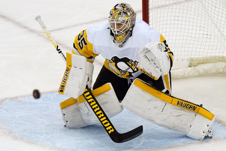 Pittsburgh Penguins goaltender Tristan Jarry (35) makes a save during the second period of an NHL hockey game against the New Jersey Devils, Sunday, April 11, 2021, in Newark, N.J. (AP Photo/Kathy Willens)