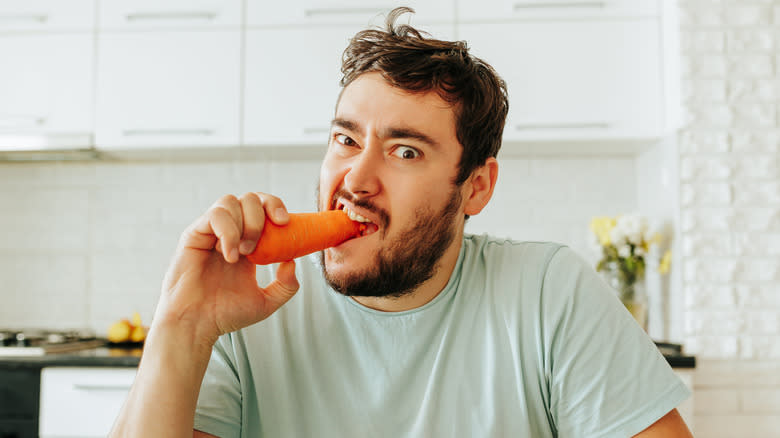 Man eating a carrot