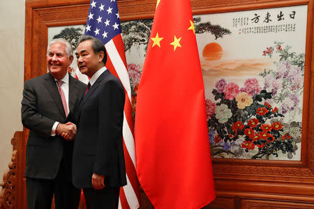 U.S. Secretary of State Rex Tillerson (L) shakes hands with Chinese Foreign Minister Wang Yi before a meeting at the Great Hall of the People in Beijing, China September 30, 2017. REUTERS/Andy Wong/Pool