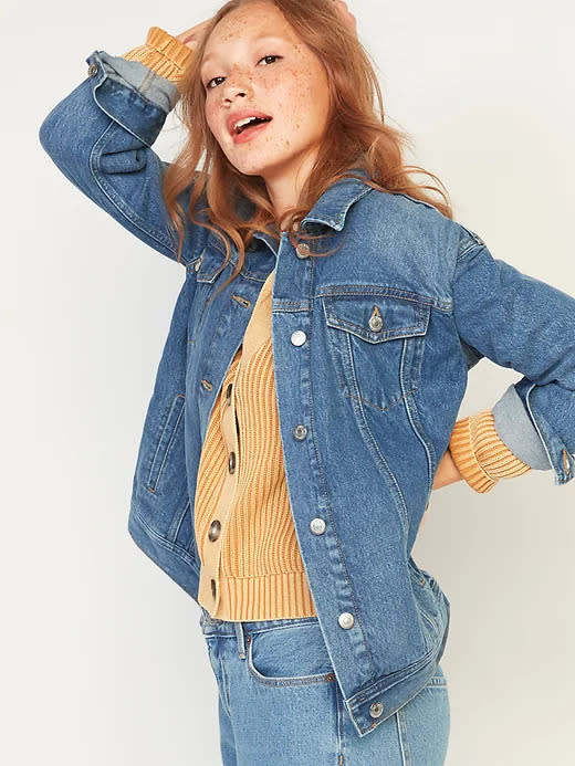 Model wears Oversized Boyfriend Jean Jacket in medium blue. Image via Old Navy.