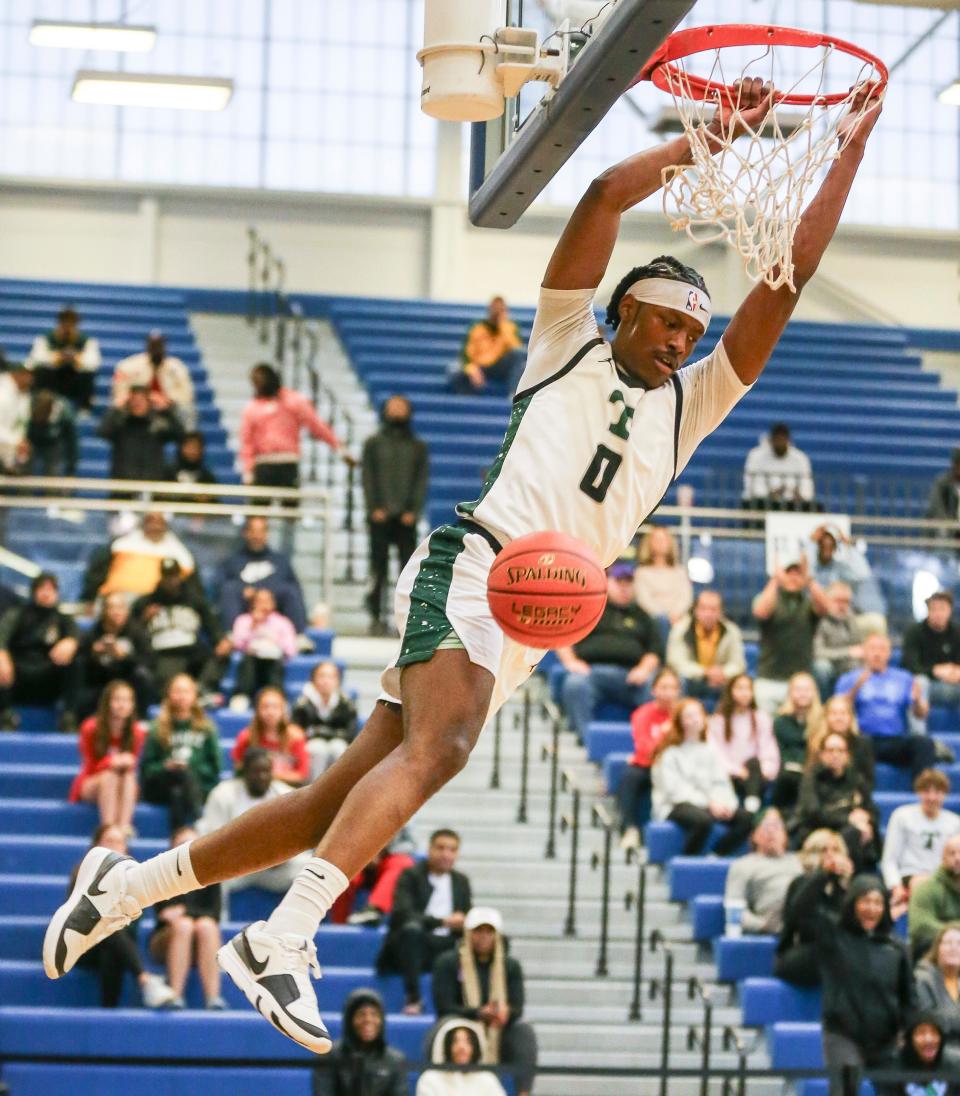 Trinity's Julius Edmonds dunks against Manual in the first half of a Seventh Region semifinal Friday at Valley High School. Edmonds scored a game-high 22 points.