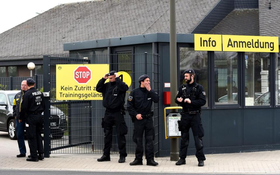 Policemen stand in front of the main entrance of the Dortmund training ground in Brackel  - Credit: PATRIK STOLLARZ/AFP