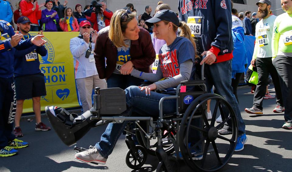 Gregory crosses the marathon's finish line in a wheelchair during a 2014 Tribute Run for survivors and first responders&nbsp;in Boston. (Photo: Brian Snyder / Reuters)