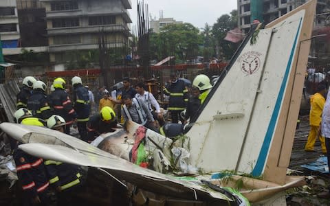 The plane hit an open area at a construction site for a multistory building - Credit: AP