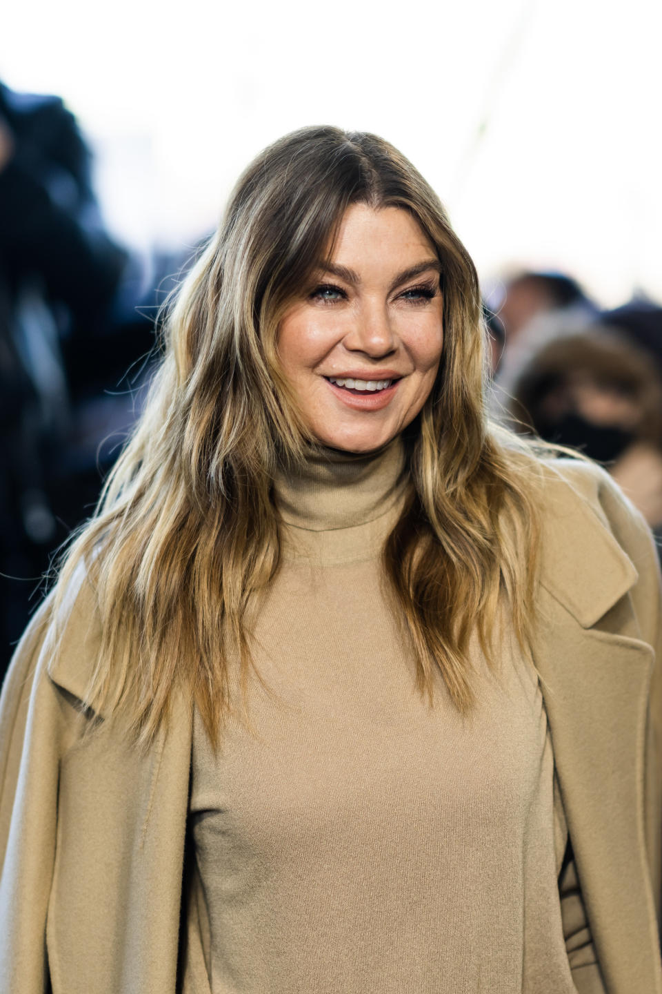 Ellen smiles at a red carpet event