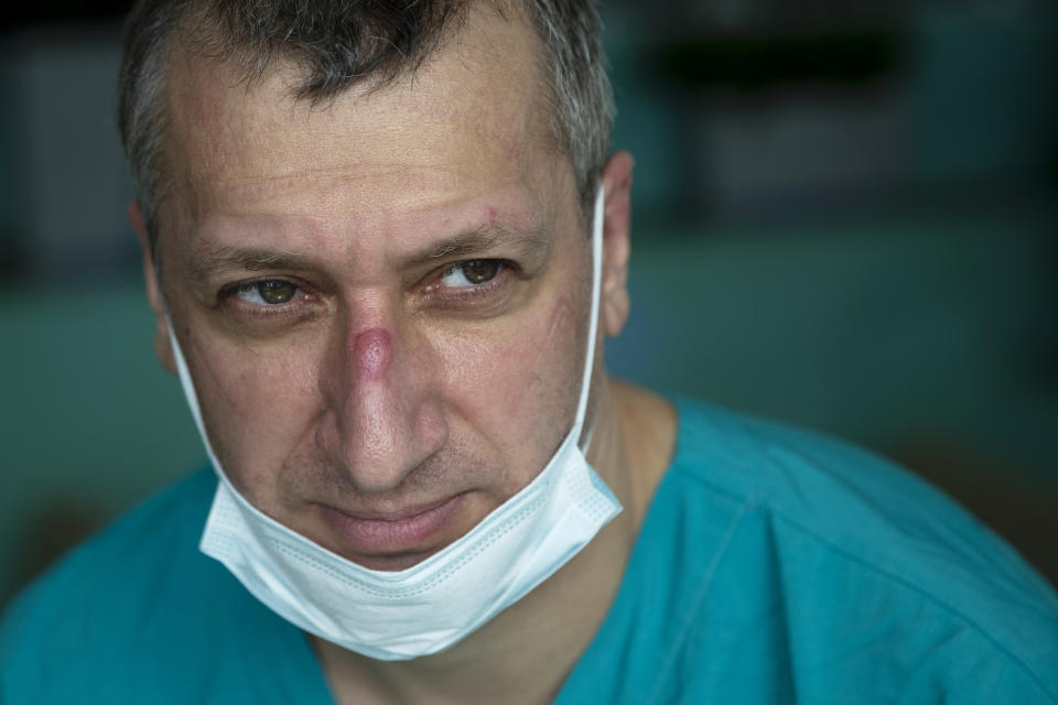 In this photo taken on Friday, May 15, 2020, Dr. Osman Osmanov has a rest after his shift at an intensive care unit of the Filatov City Clinical Hospital in Moscow, Russia. Moscow accounts for about half of all of Russia's coronavirus cases, a deluge that strains the city's hospitals and has forced Osmanov to to work every day for the past two months, sometimes for 24 hours in a row. (AP Photo/Pavel Golovkin)