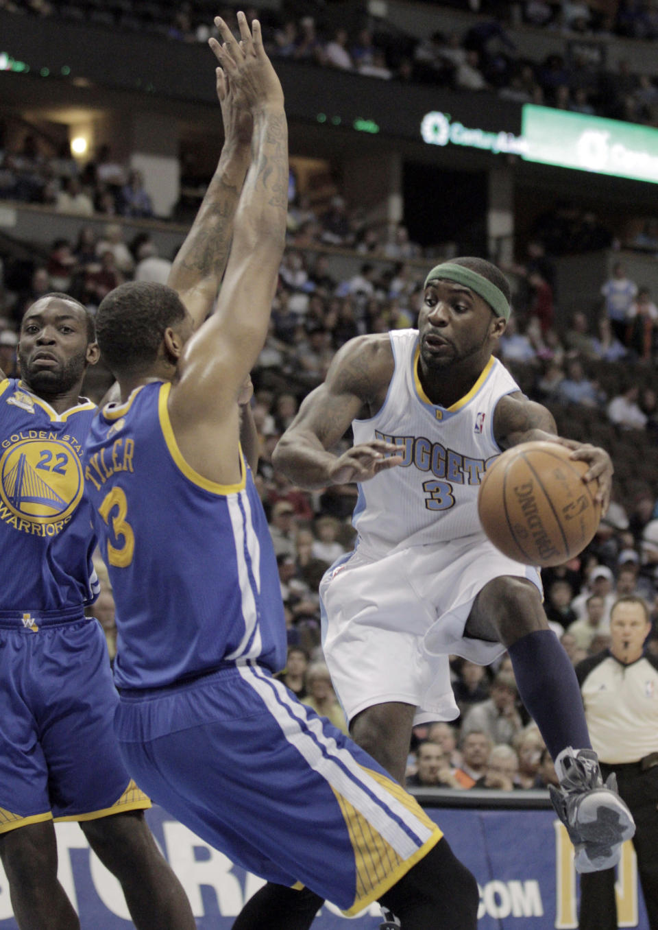 Denver Nuggets' Ty Lawson (3) passes around Golden State Warriors' Jeremy Tyler, left, in the first period of their NBA game in Denver on Monday, April 9, 2012.(AP Photo/Joe Mahoney)