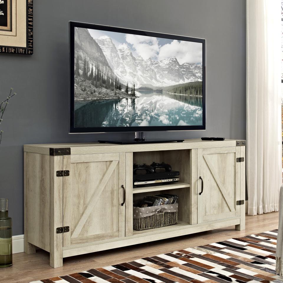 Manor Park Modern Farmhouse Barn Door TV Stand (up to 64” TVs) (Photo: Walmart)